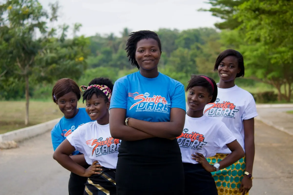 A group of young women in matching T-shirts outdoors